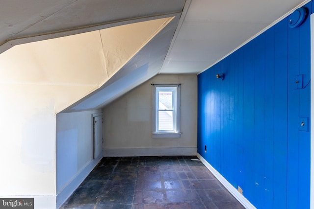 additional living space featuring lofted ceiling