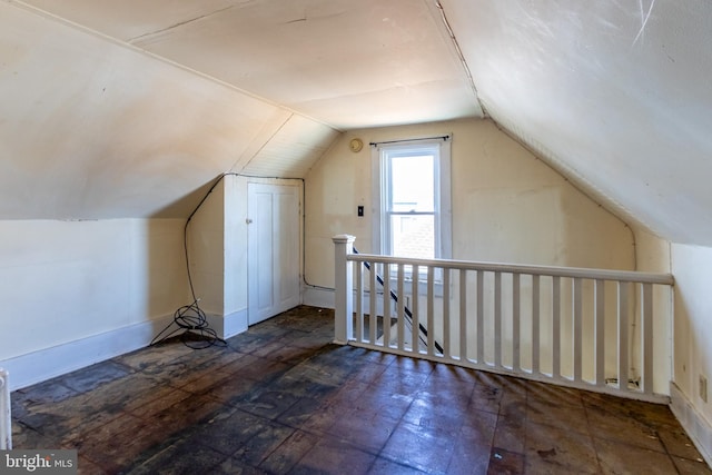 bonus room with lofted ceiling and dark hardwood / wood-style floors