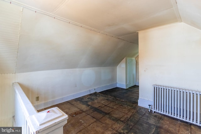 additional living space with lofted ceiling and radiator