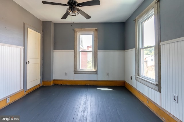 spare room with dark hardwood / wood-style floors and ceiling fan