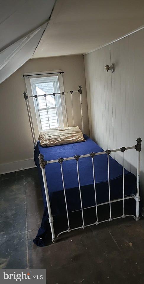 unfurnished bedroom with lofted ceiling