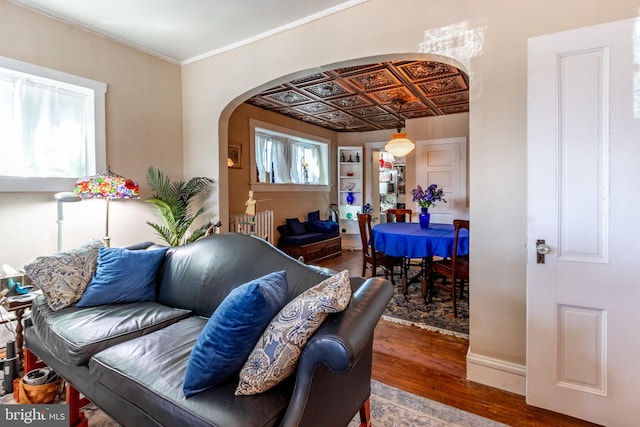 living room with hardwood / wood-style floors and crown molding