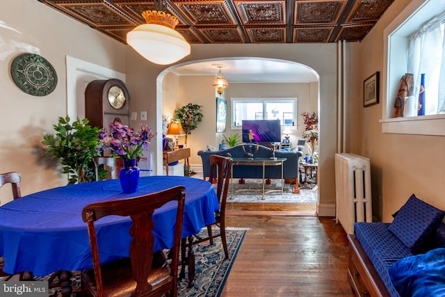 dining space with dark hardwood / wood-style floors and radiator heating unit