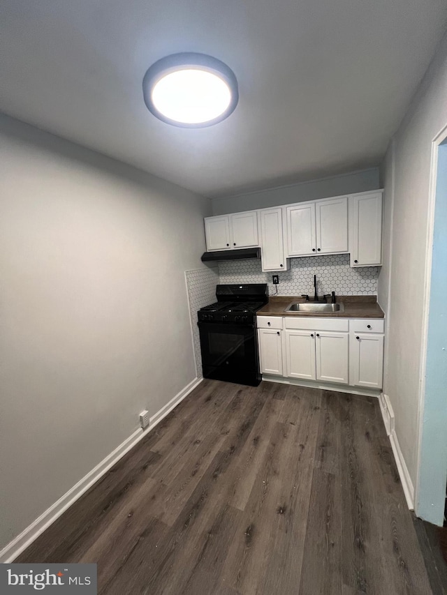 kitchen featuring backsplash, black range with gas stovetop, sink, and white cabinets