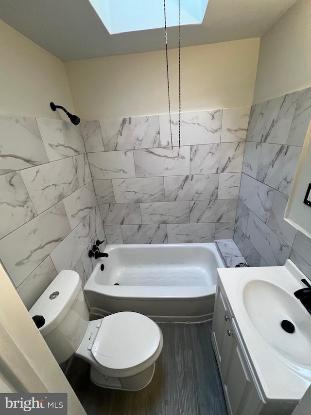 full bathroom with shower / bath combination, tile walls, hardwood / wood-style floors, a skylight, and toilet