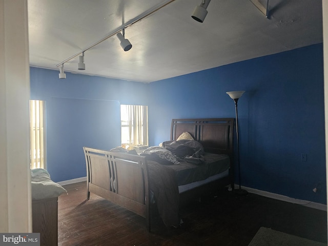 6606 Park Heights Ave Unit 905, Baltimore, MD 21215 - bedroom with rail lighting, wood finished floors, and baseboards