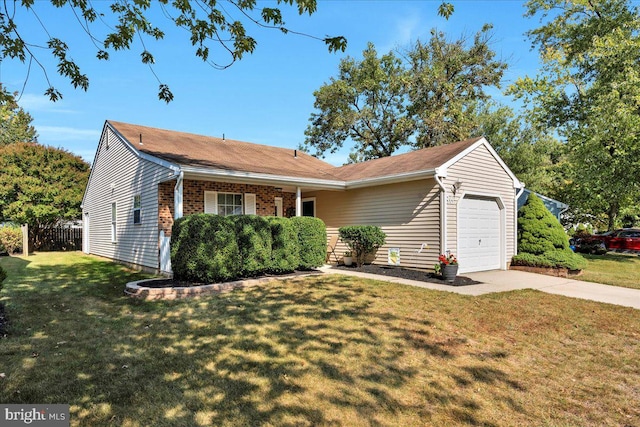 view of front of property featuring a front yard and a garage