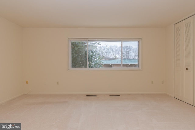 unfurnished bedroom with light colored carpet