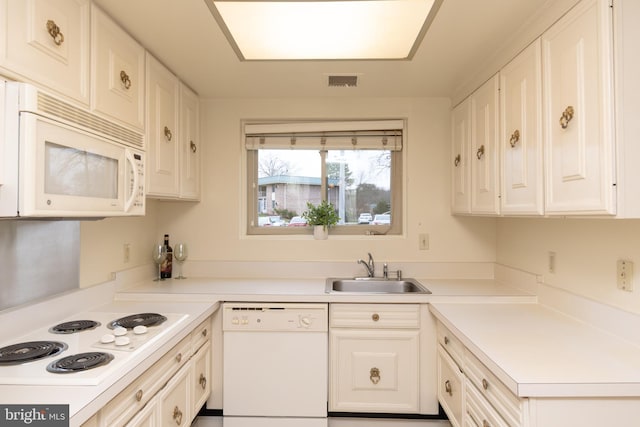 kitchen featuring white cabinets, white appliances, and sink