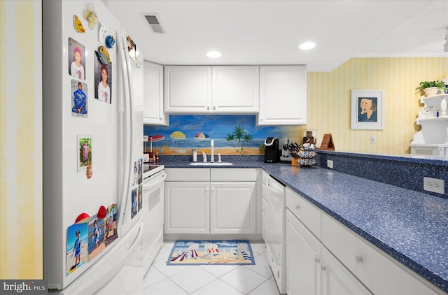 kitchen with white appliances, sink, and white cabinets