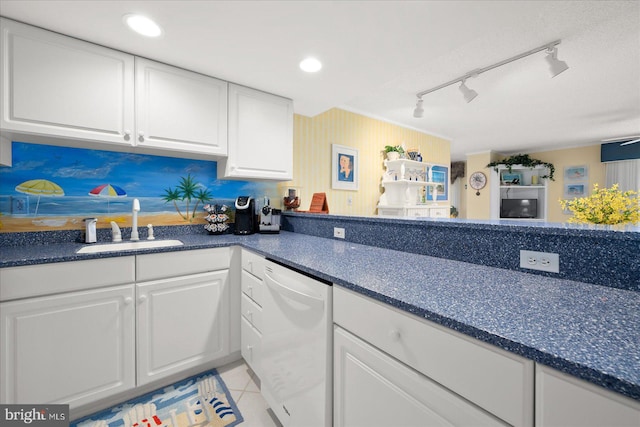 kitchen with rail lighting, light tile patterned flooring, white cabinets, white dishwasher, and sink