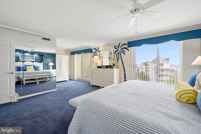 carpeted bedroom featuring ceiling fan, access to exterior, and a textured ceiling