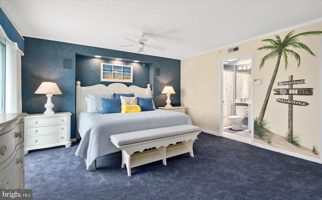 bedroom featuring a textured ceiling, ensuite bath, ceiling fan, and dark colored carpet