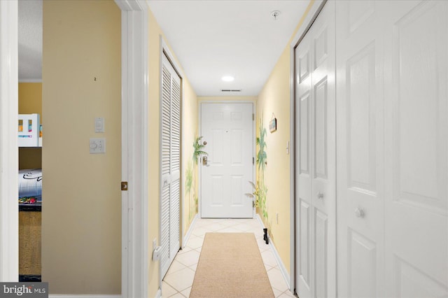 hall featuring light tile patterned floors