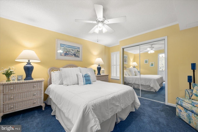 carpeted bedroom featuring ceiling fan, a textured ceiling, a closet, multiple windows, and crown molding