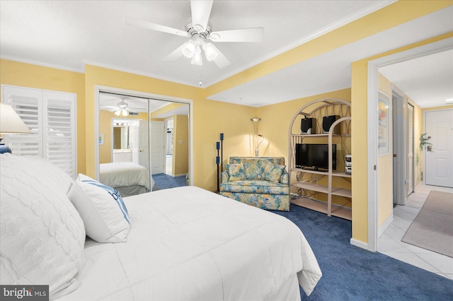 carpeted bedroom featuring ornamental molding, ceiling fan, and a closet