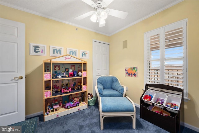 sitting room featuring ceiling fan, carpet floors, ornamental molding, and a textured ceiling