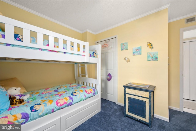 bedroom featuring dark carpet, a closet, a textured ceiling, and ornamental molding