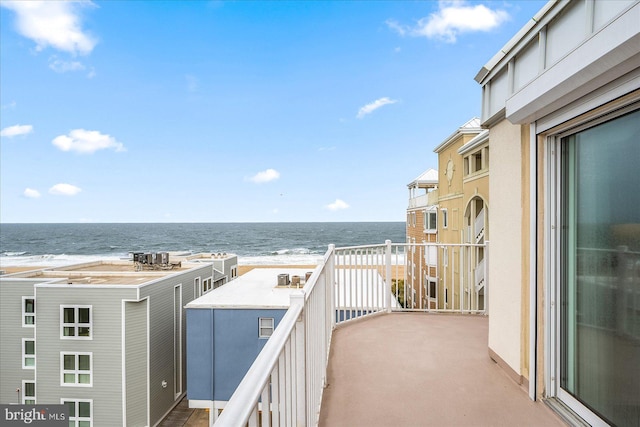 balcony with a water view and a beach view