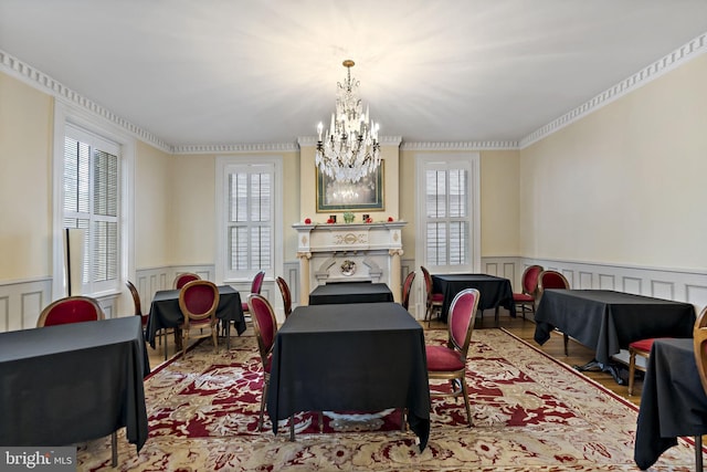 dining space featuring crown molding, an inviting chandelier, and plenty of natural light