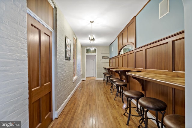 interior space featuring light wood-type flooring and brick wall