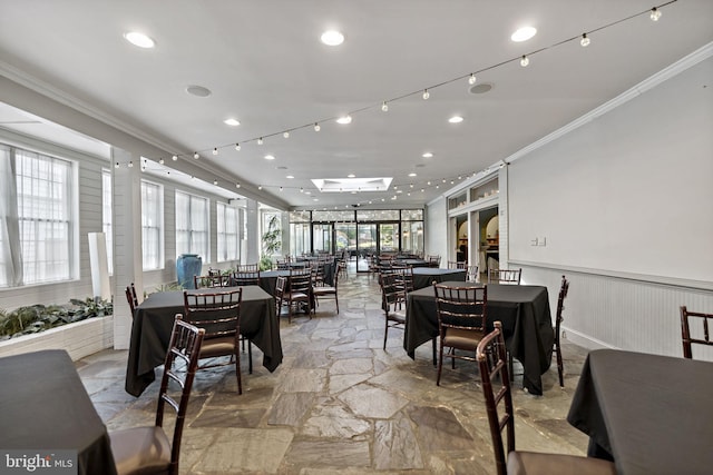 dining space featuring crown molding