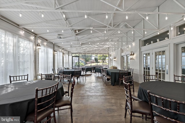 dining area with beamed ceiling, hardwood / wood-style flooring, high vaulted ceiling, and wooden ceiling