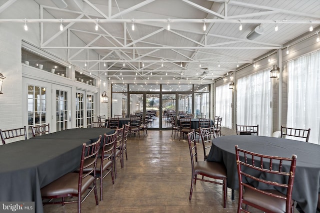 dining room with high vaulted ceiling, beam ceiling, dark wood-type flooring, and french doors