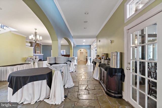 dining area featuring a notable chandelier and crown molding