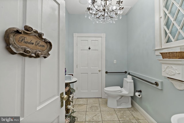 bathroom featuring toilet and a chandelier