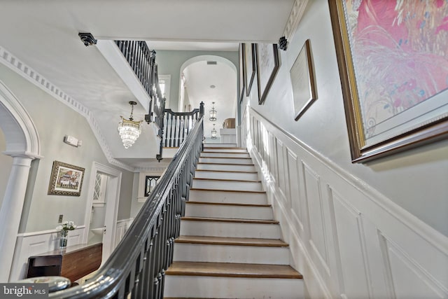 staircase featuring a notable chandelier