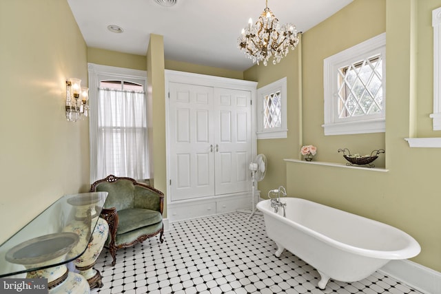 bathroom featuring a tub to relax in and tile patterned flooring