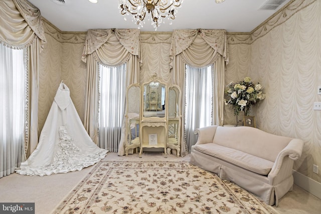 living area featuring carpet flooring and a chandelier