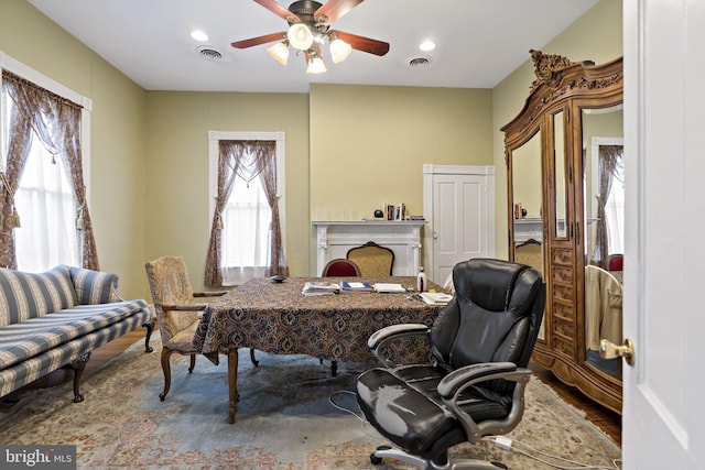 office space featuring ceiling fan and hardwood / wood-style flooring