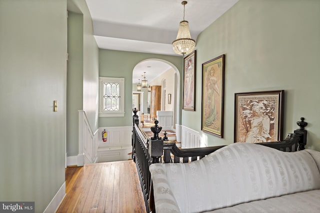 bedroom featuring light hardwood / wood-style flooring and a chandelier