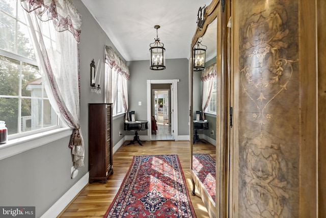 entryway with light hardwood / wood-style flooring and a chandelier