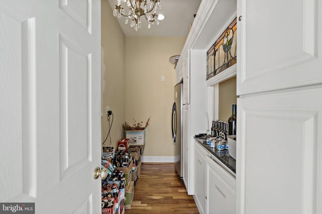 interior space with dark hardwood / wood-style floors and a notable chandelier