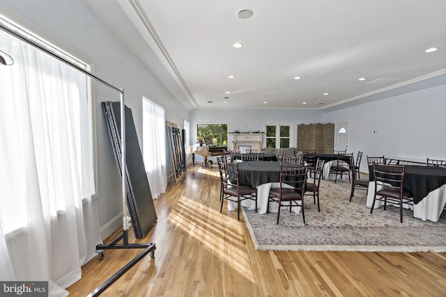 dining area featuring light hardwood / wood-style flooring and crown molding