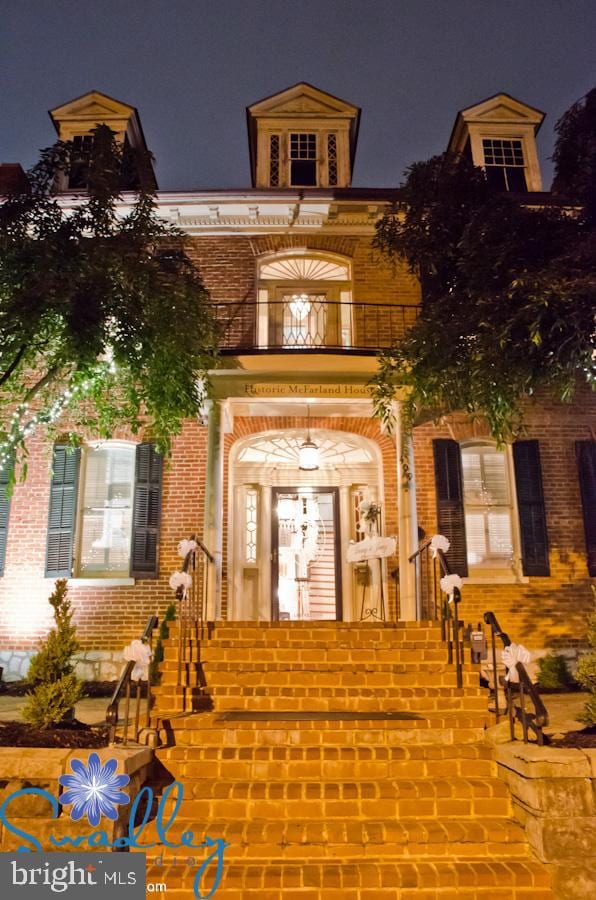 view of exterior entry at twilight