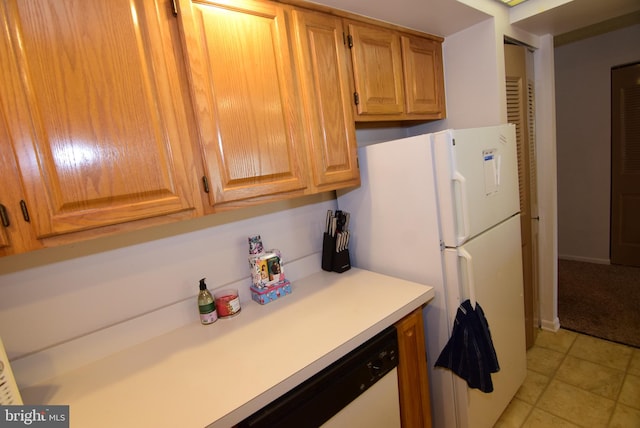 kitchen featuring dishwasher and light tile patterned flooring