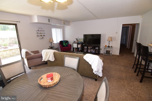 dining room featuring a textured ceiling and carpet