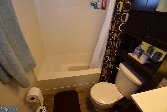 full bathroom with vanity, shower / bath combination with curtain, hardwood / wood-style flooring, and toilet