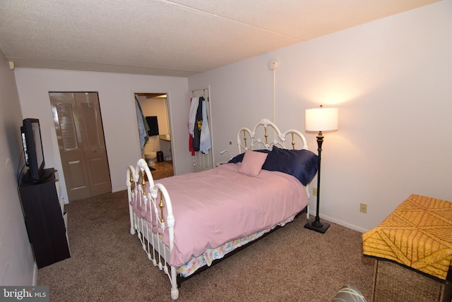 carpeted bedroom featuring a textured ceiling