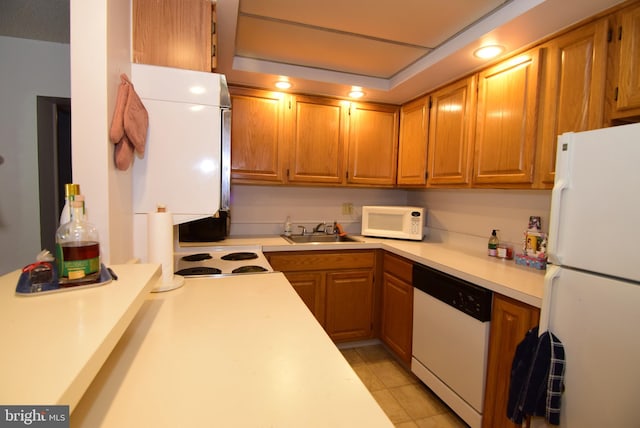 kitchen with white appliances, light tile patterned flooring, and sink