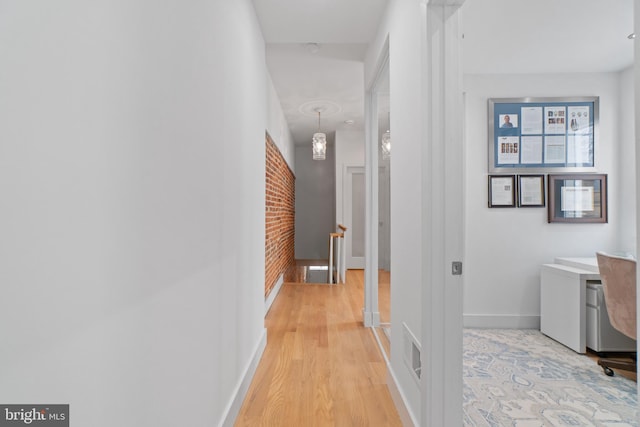 hall with light hardwood / wood-style flooring