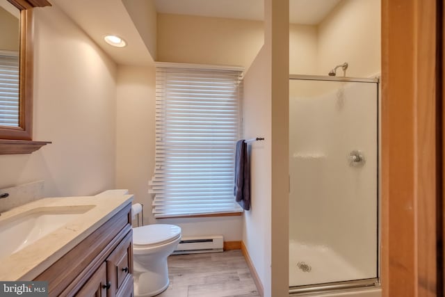 bathroom with a baseboard radiator, hardwood / wood-style floors, toilet, vanity, and a shower with shower door