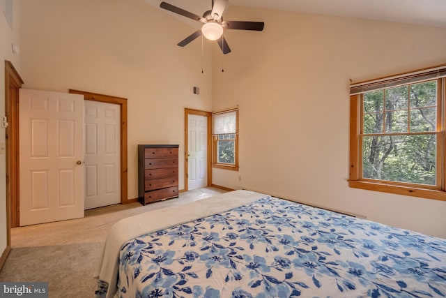 bedroom featuring light colored carpet, high vaulted ceiling, and ceiling fan