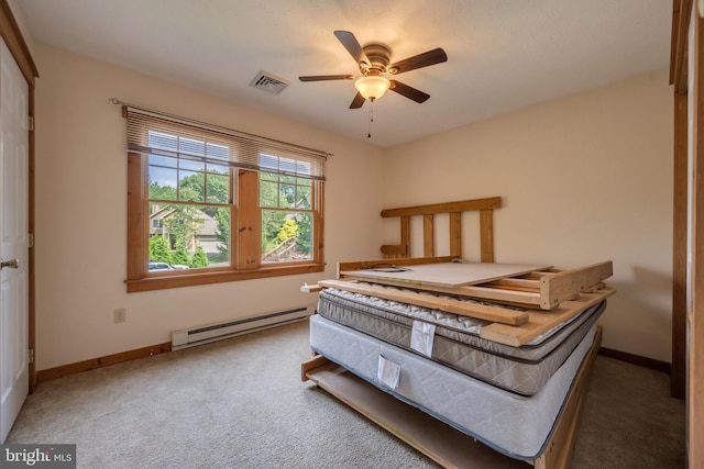 bedroom featuring ceiling fan, carpet floors, and a baseboard heating unit