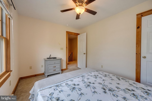 unfurnished bedroom with ceiling fan and light colored carpet