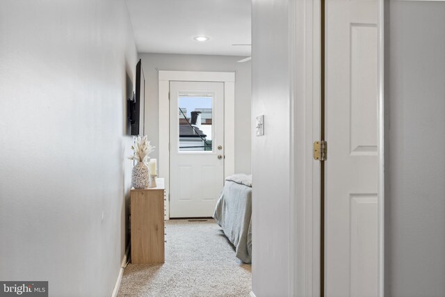 corridor with light colored carpet